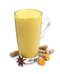 Photo of Delicious turmeric latte in glass cup, roots and anise star isolated on white