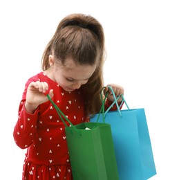 Cute little girl with shopping bags on white background