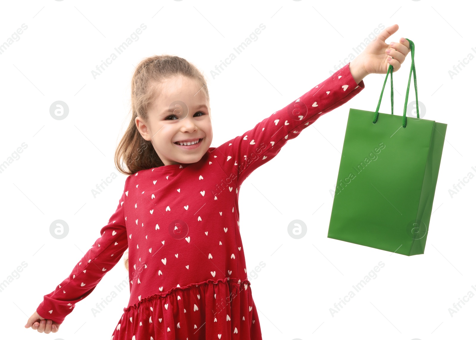 Photo of Happy little girl with shopping bag on white background