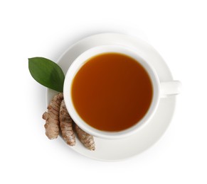 Photo of Aromatic turmeric tea in cup, roots and green leaf isolated on white, top view