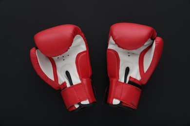 Photo of Boxing gloves on black background, flat lay. Sports equipment