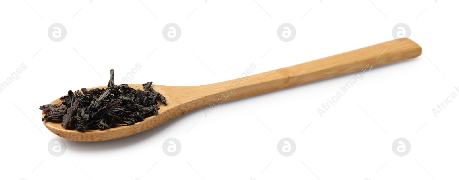 Photo of Dry tea leaves in wooden spoon isolated on white