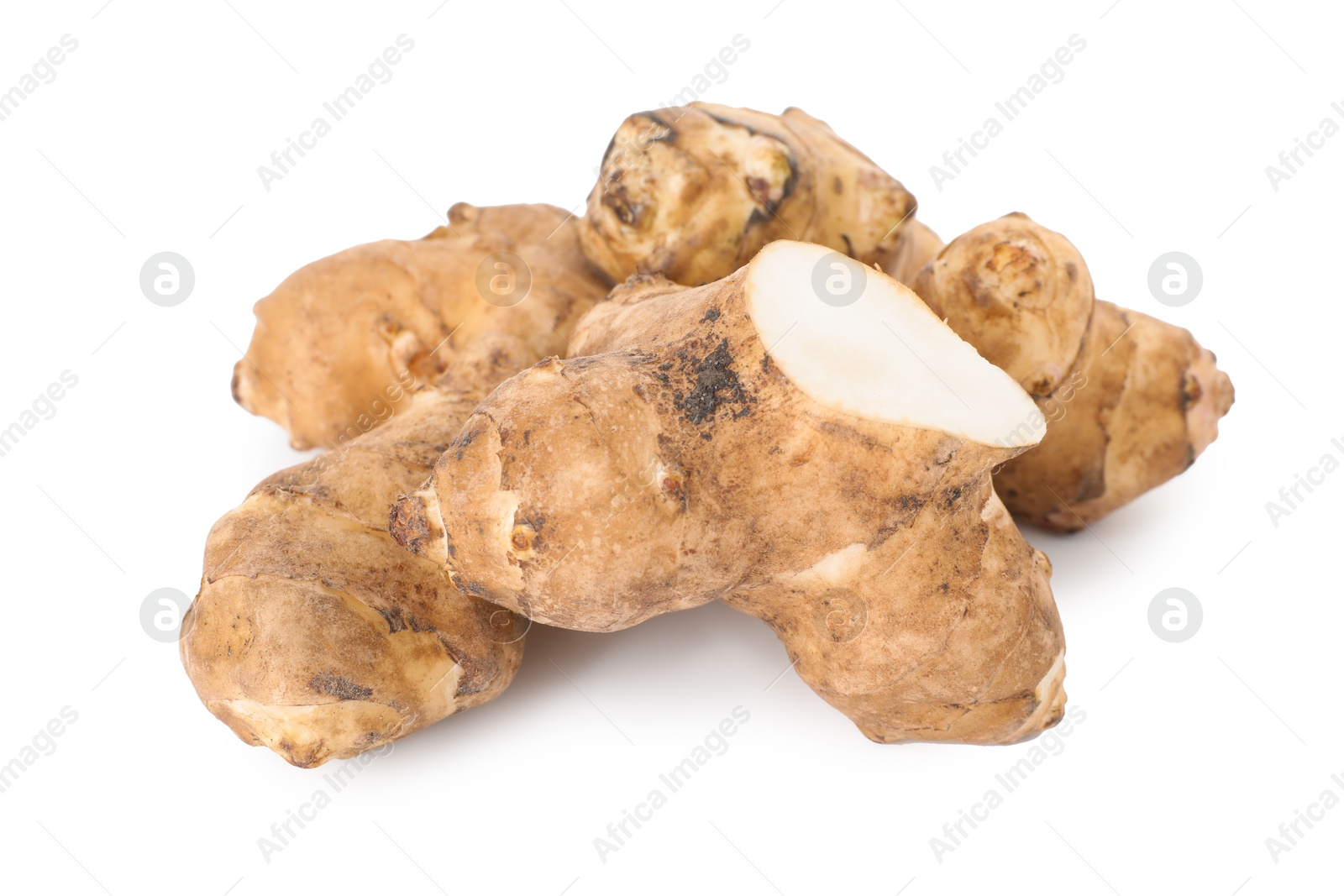 Photo of Fresh Jerusalem artichokes isolated on white. Root vegetable