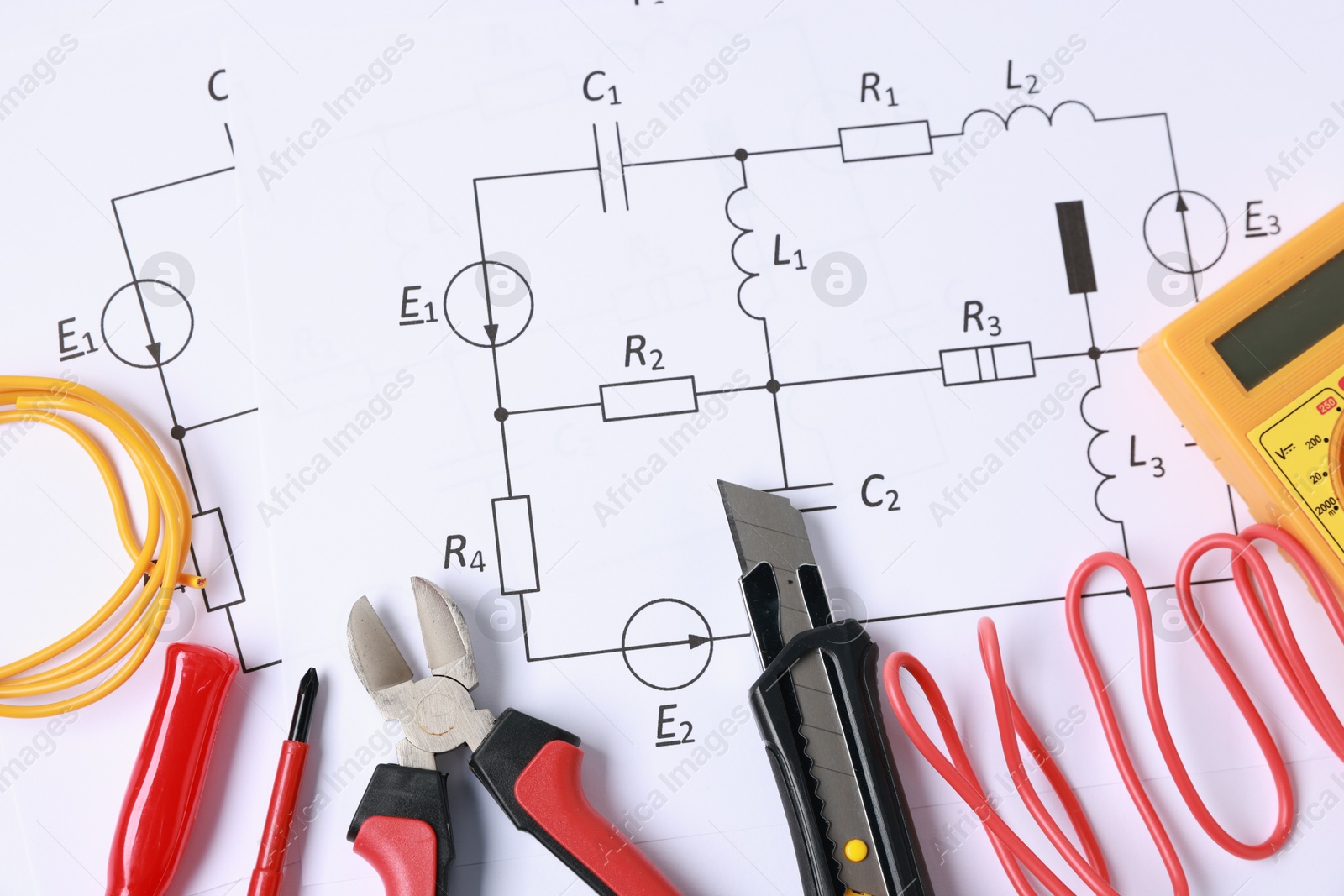 Photo of Different electrical tools on circuit diagrams, flat lay