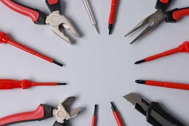 Photo of Frame of different electrical tools on grey background, flat lay. Space for text