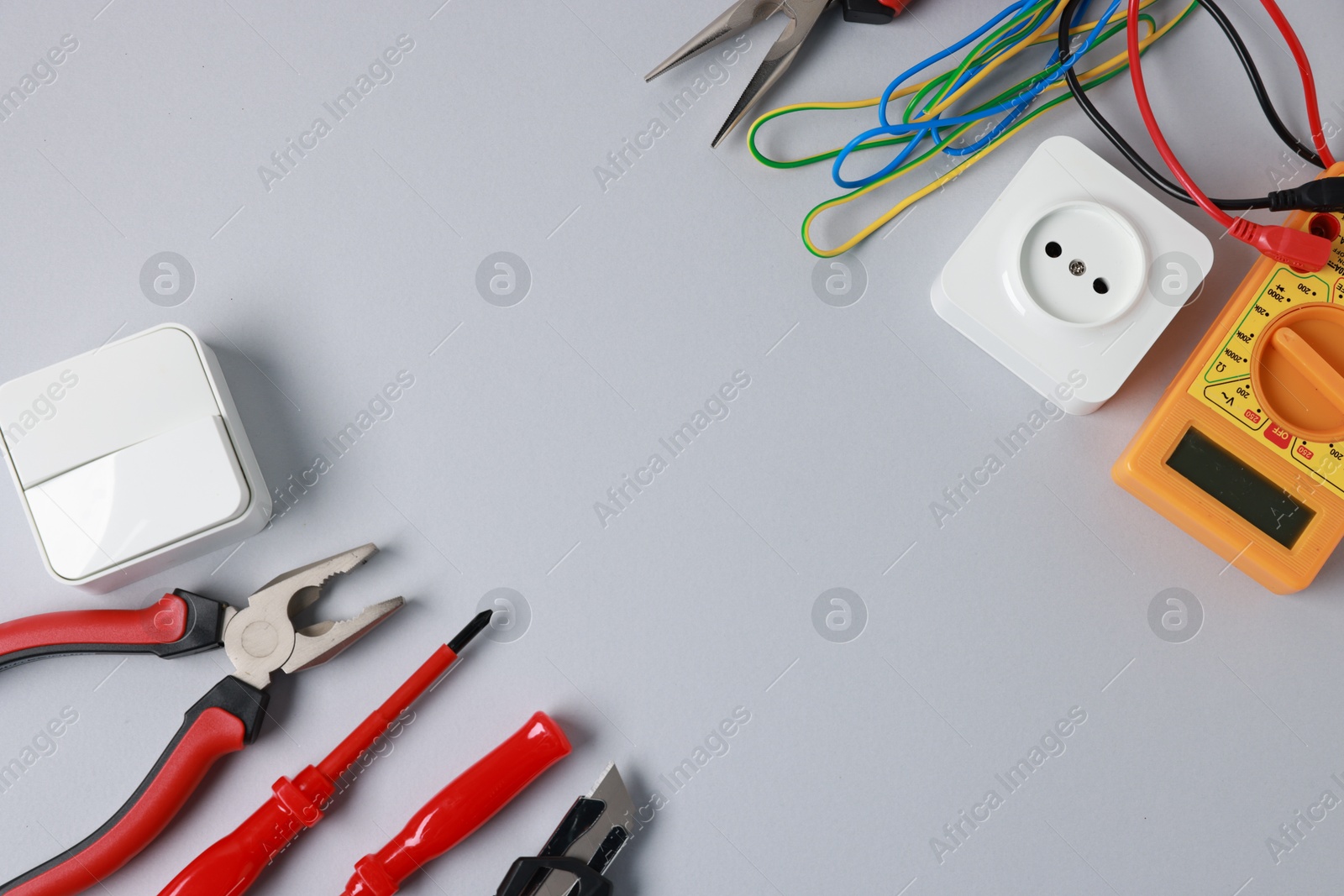 Photo of Different electrical tools on grey background, flat lay. Space for text