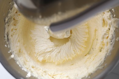 Photo of Mixing whipped cream in bowl with stand mixer, top view