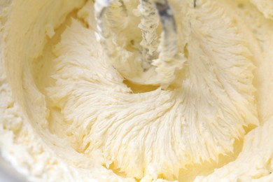 Photo of Mixing whipped cream in bowl with stand mixer, closeup