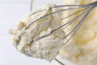 Photo of Bowl with whisk and whipped cream on white table, top view