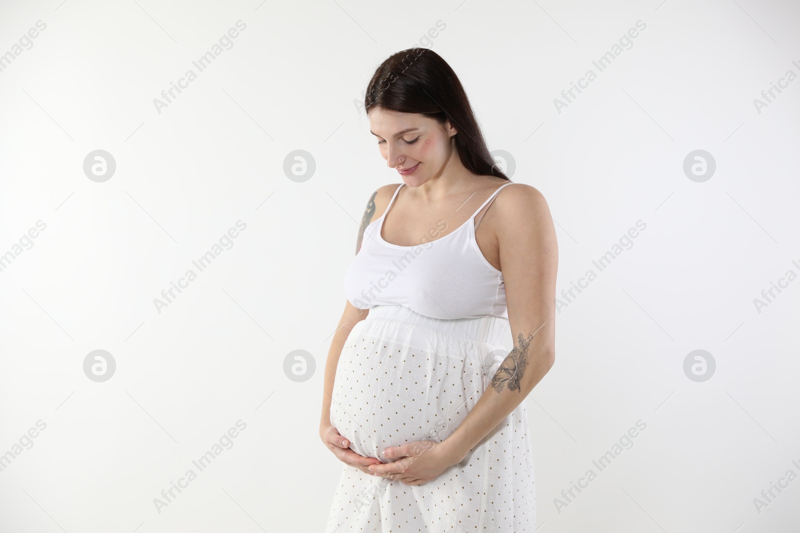 Photo of Beautiful pregnant woman with cute belly on white background