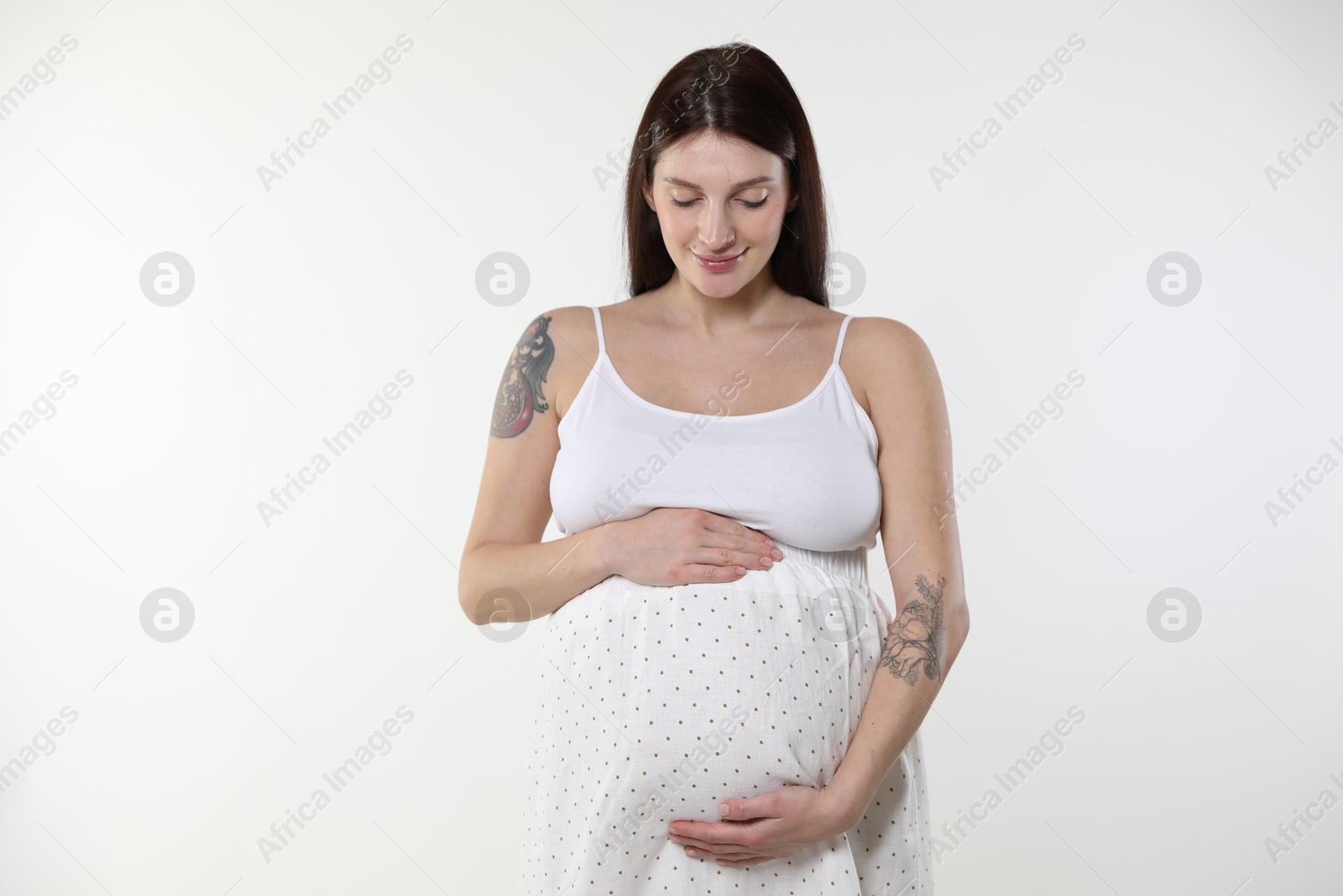 Photo of Beautiful pregnant woman with cute belly on white background