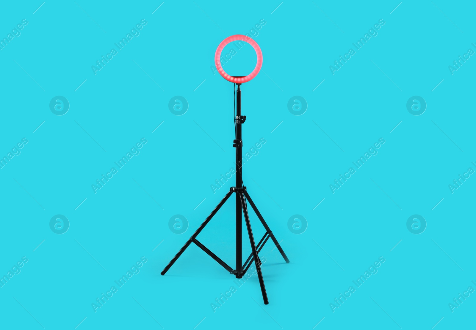 Photo of Ring lamp on stand against light blue background