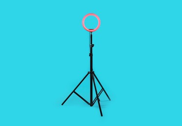 Photo of Ring lamp on stand against light blue background