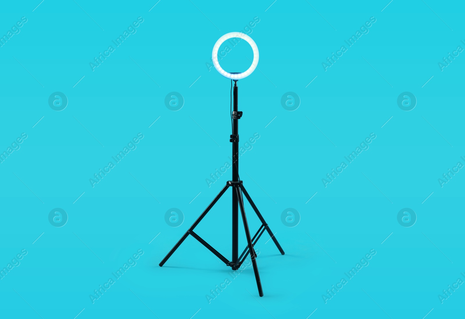 Photo of Ring lamp on stand against light blue background