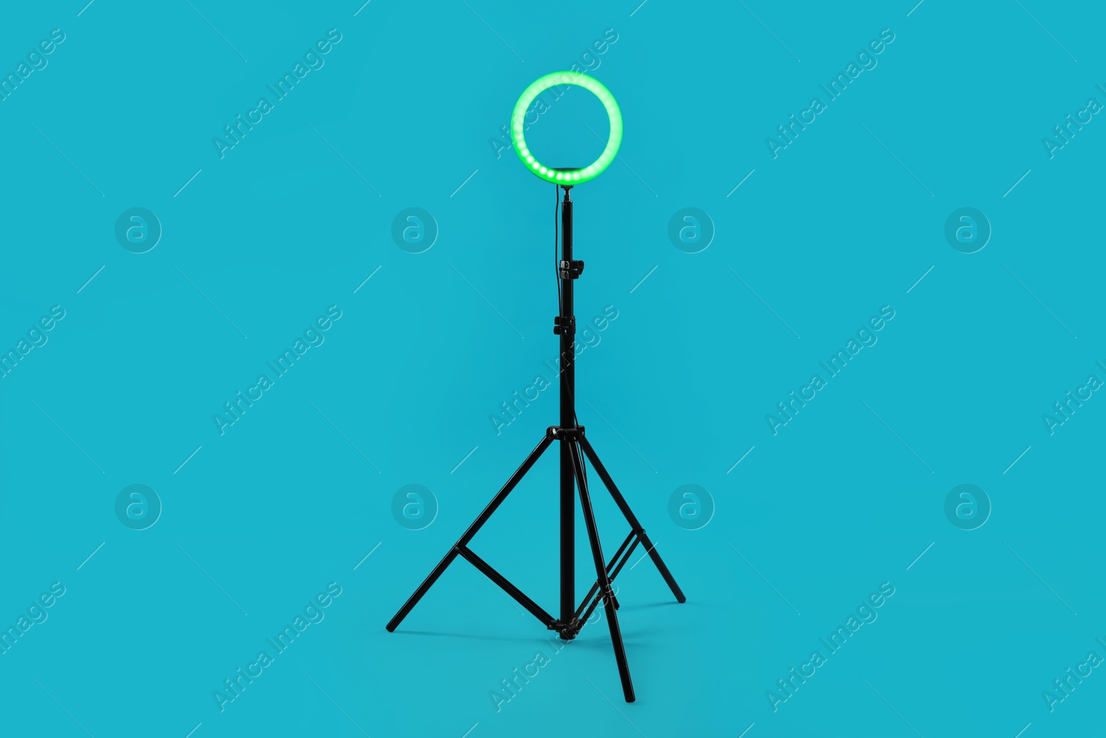 Photo of Ring lamp on stand against light blue background