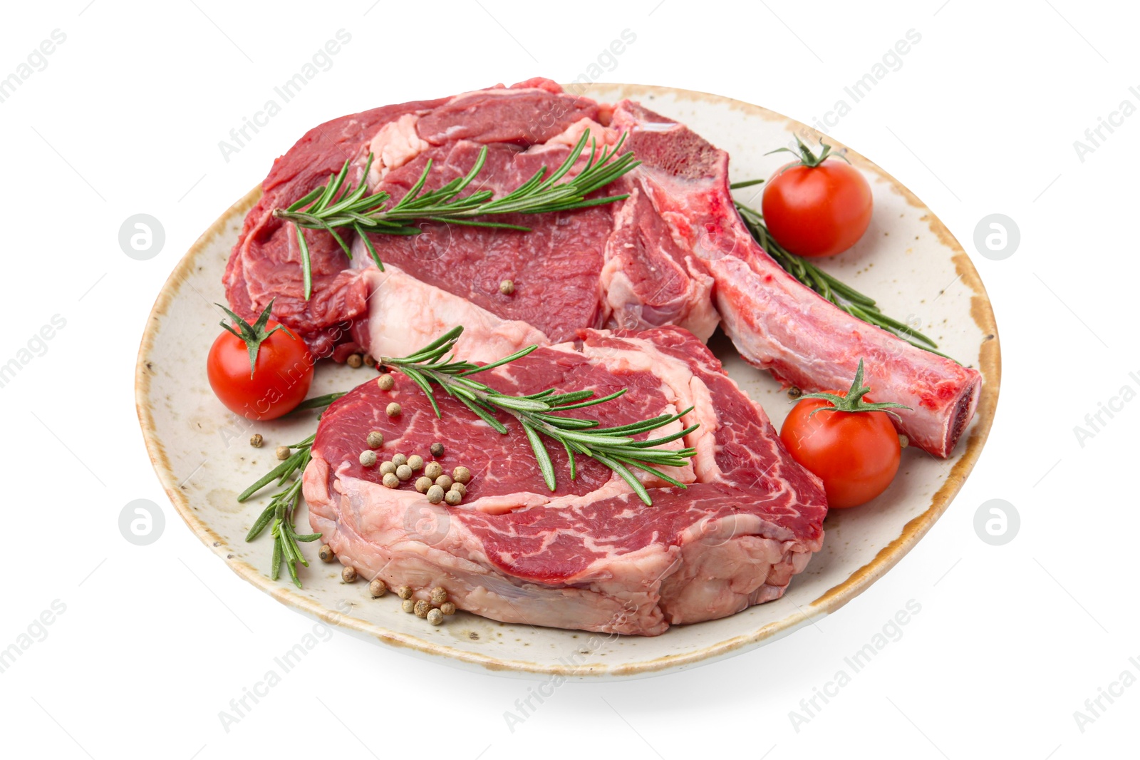 Photo of Pieces of raw beef meat, spices and tomatoes isolated on white