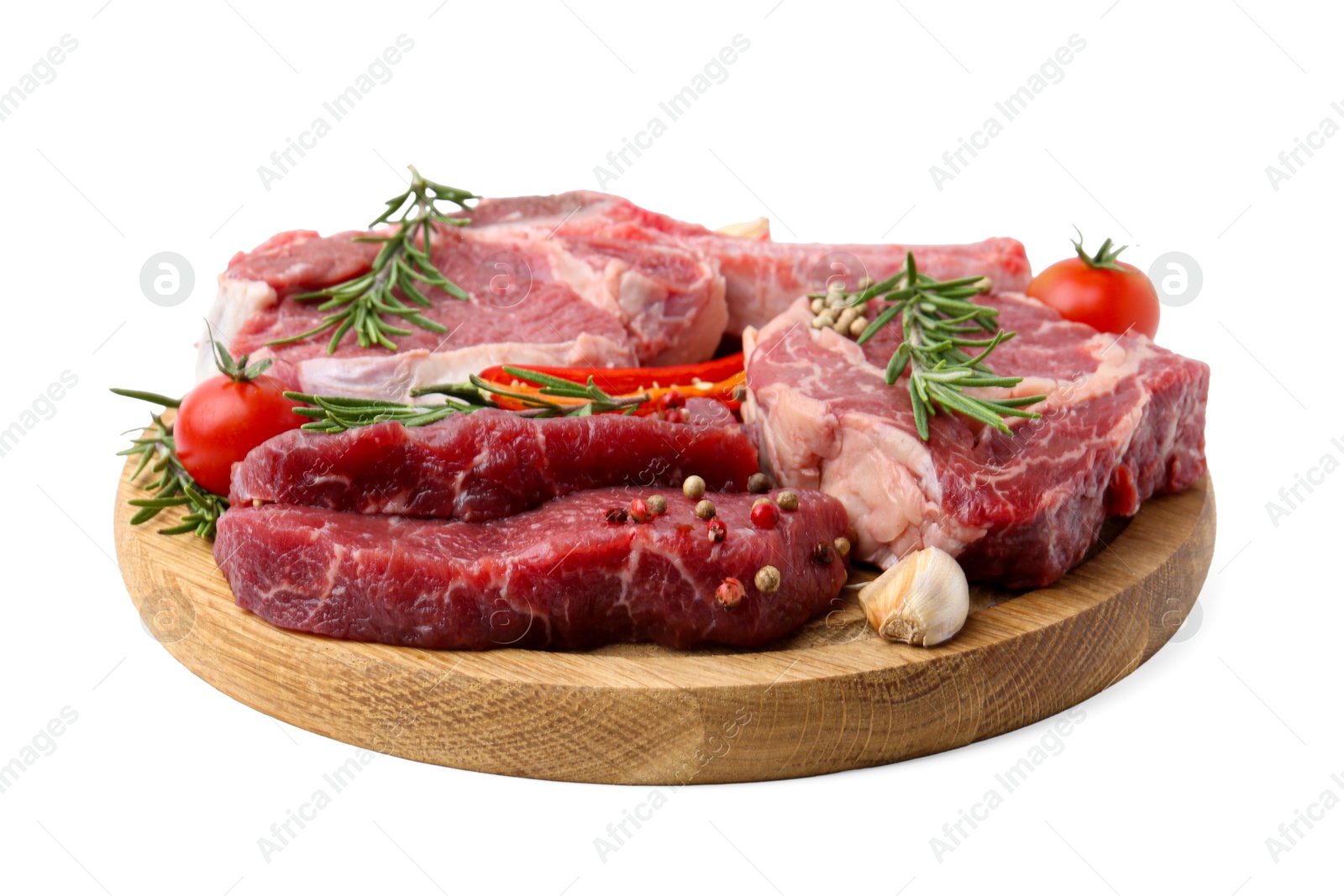 Photo of Pieces of raw beef meat, spices and tomatoes isolated on white