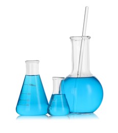 Photo of Laboratory glassware with blue liquid isolated on white