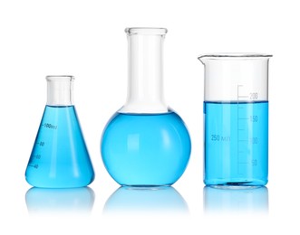 Photo of Laboratory glassware with blue liquid isolated on white