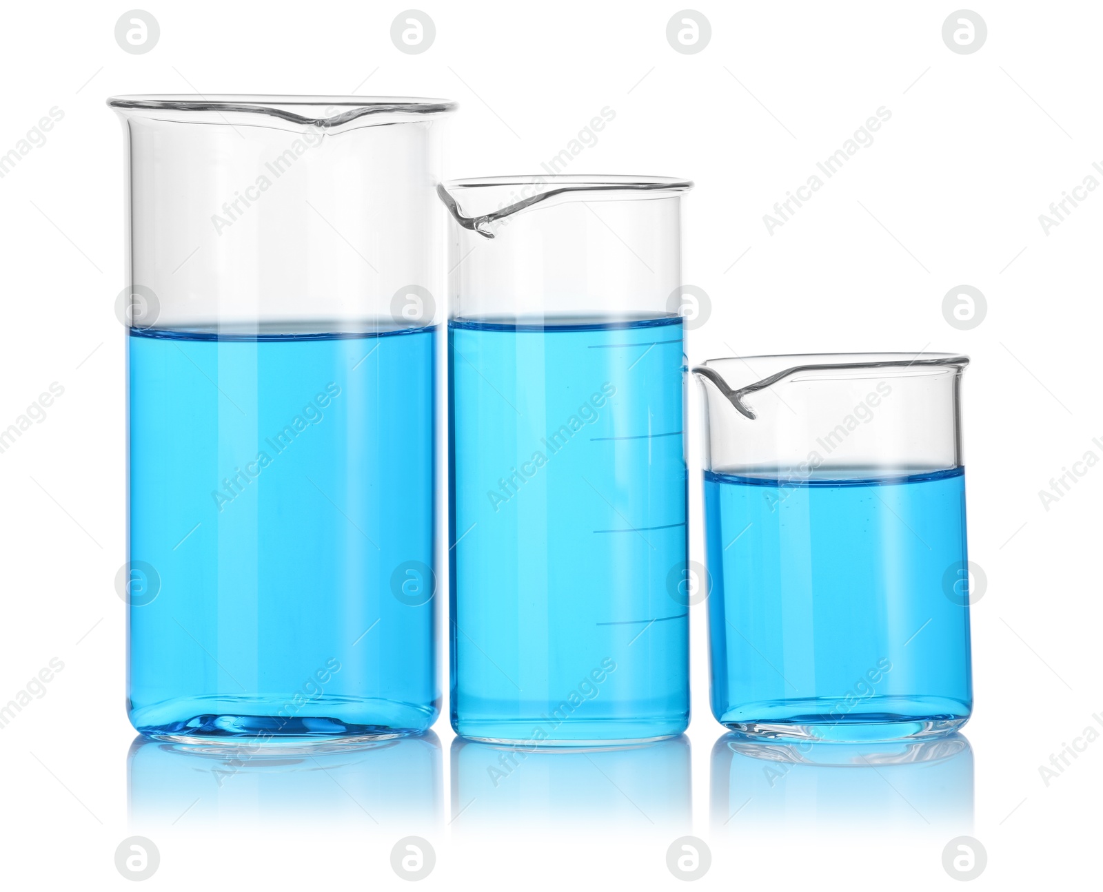 Photo of Different beakers with blue liquid isolated on white