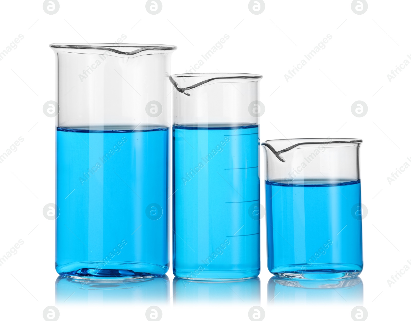 Photo of Different beakers with blue liquid isolated on white