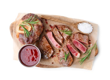 Photo of Pieces of delicious beef meat, spices and sauce isolated on white, top view