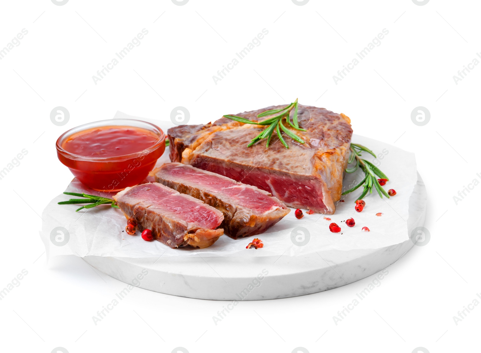 Photo of Pieces of delicious beef meat, spices and sauce isolated on white