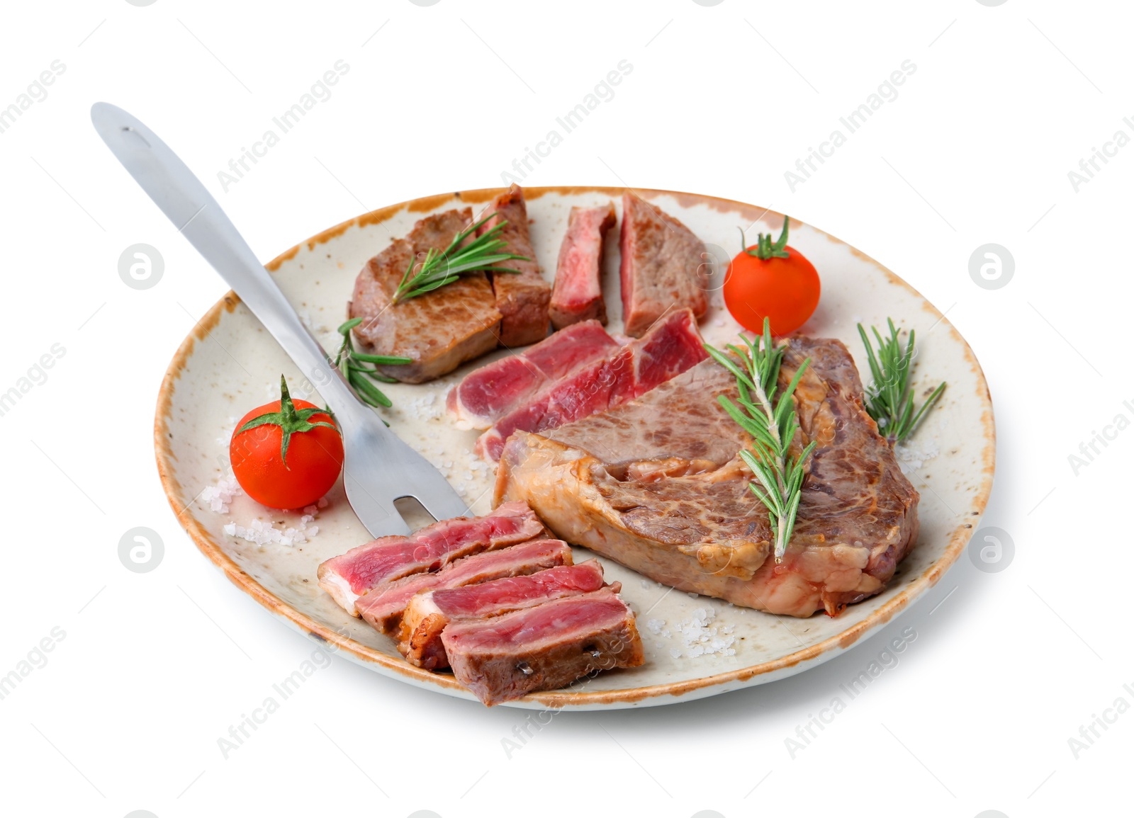 Photo of Pieces of delicious beef meat, spices, tomatoes and carving fork isolated on white