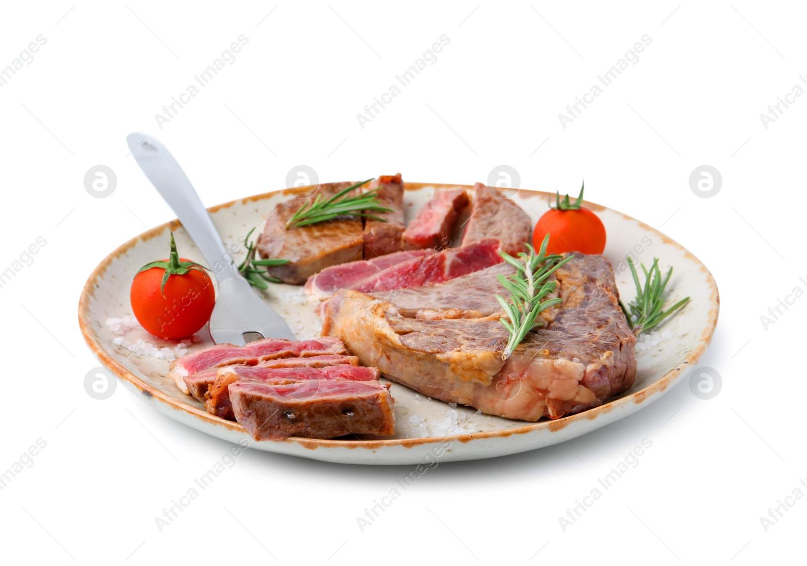 Photo of Pieces of delicious beef meat, spices, tomatoes and carving fork isolated on white