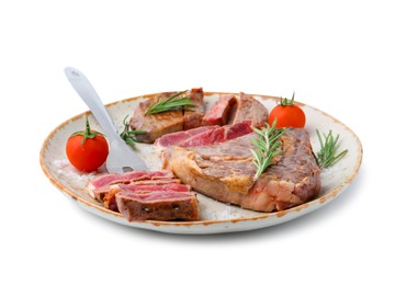 Photo of Pieces of delicious beef meat, spices, tomatoes and carving fork isolated on white