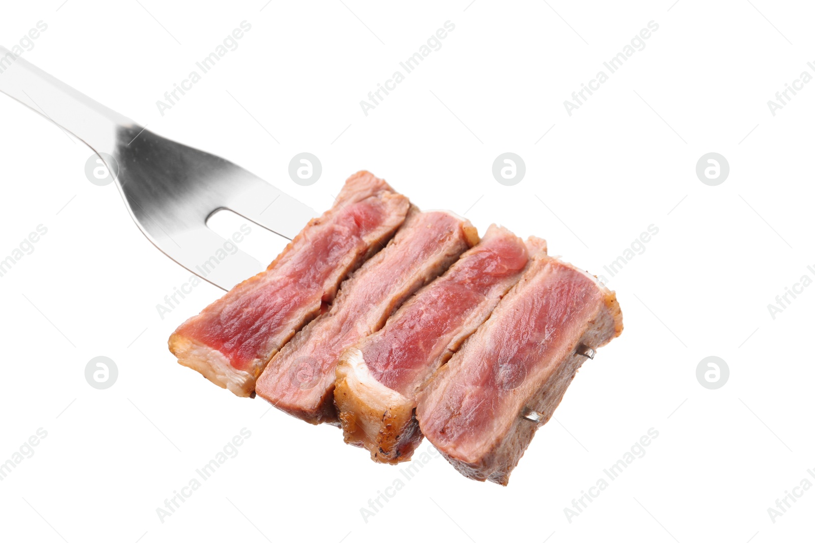 Photo of Carving fork with pieces of delicious beef meat isolated on white