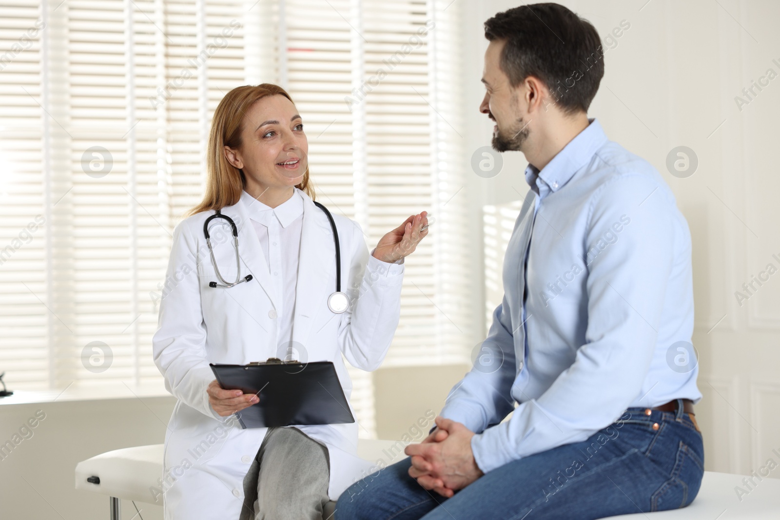 Photo of Man having appointment with cardiologist in clinic