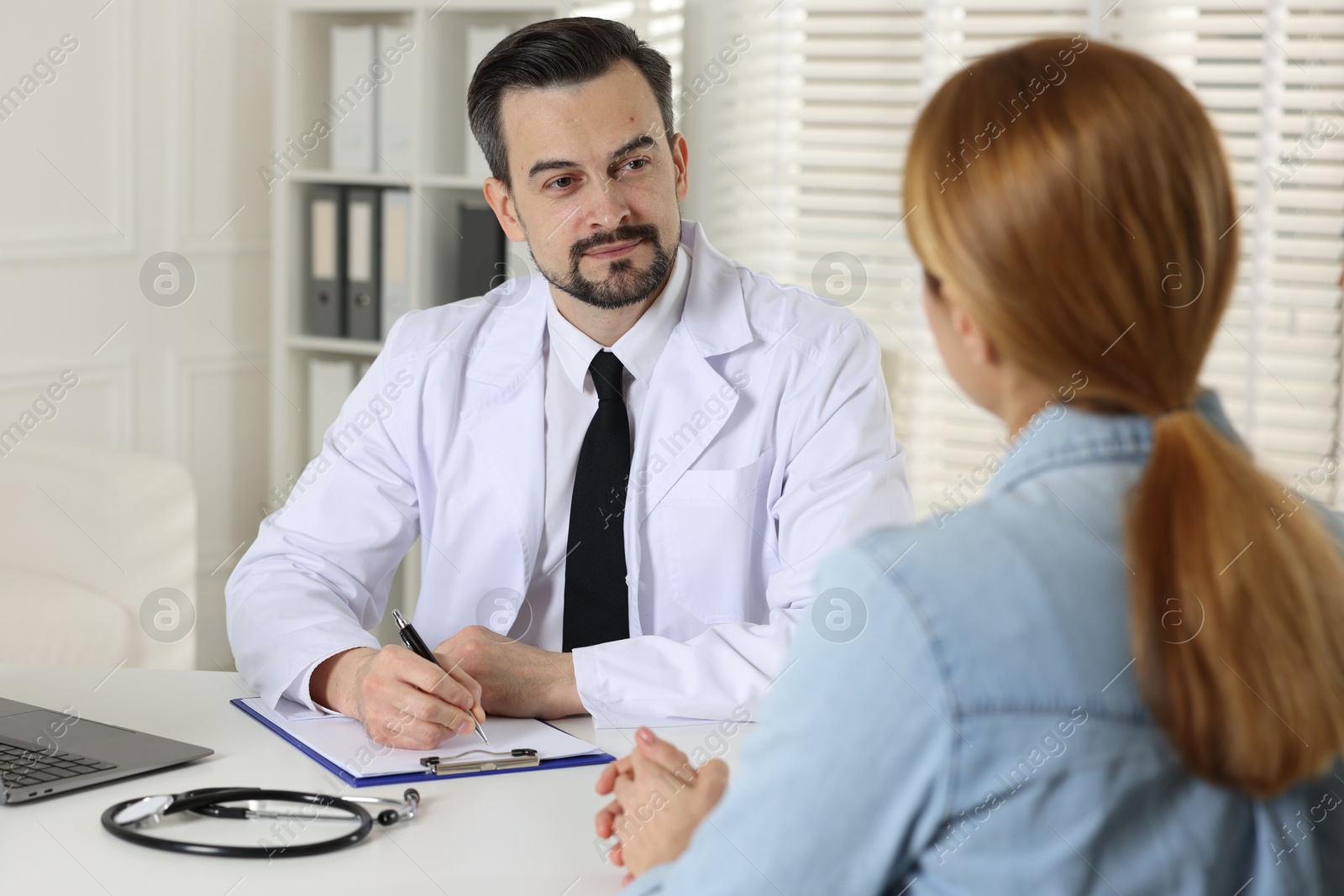 Photo of Woman having appointment with cardiologist in clinic