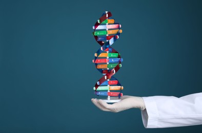 Photo of Scientist holding DNA structure model on dark blue background, closeup. Space for text