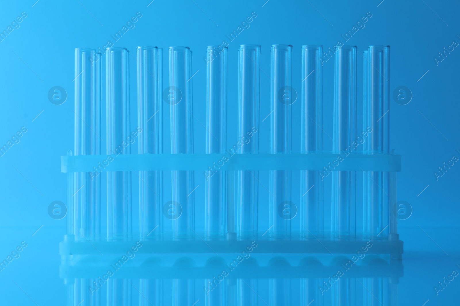 Photo of Empty test tubes on light blue background. Laboratory glassware