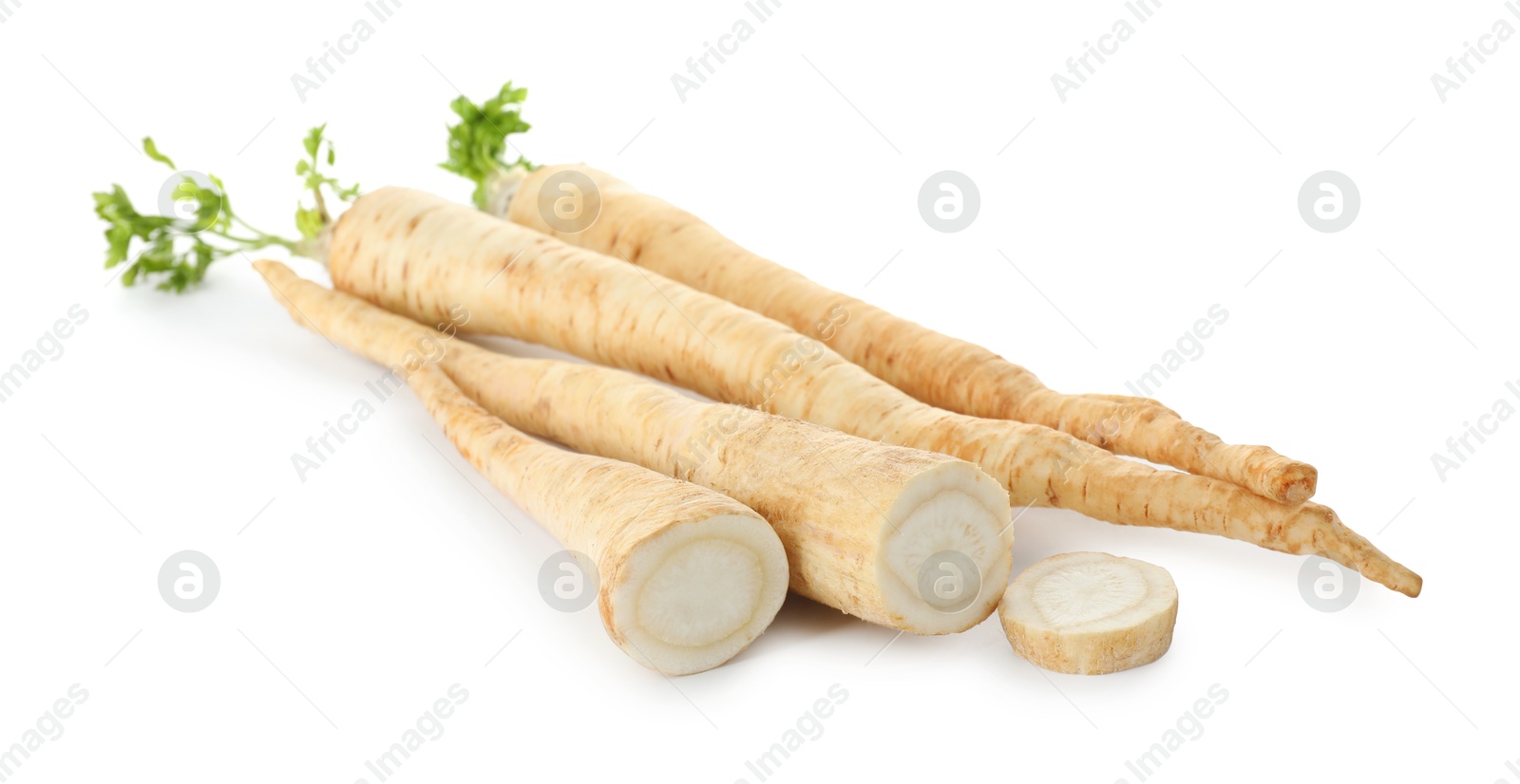 Photo of Whole and cut fresh parsley roots isolated on white