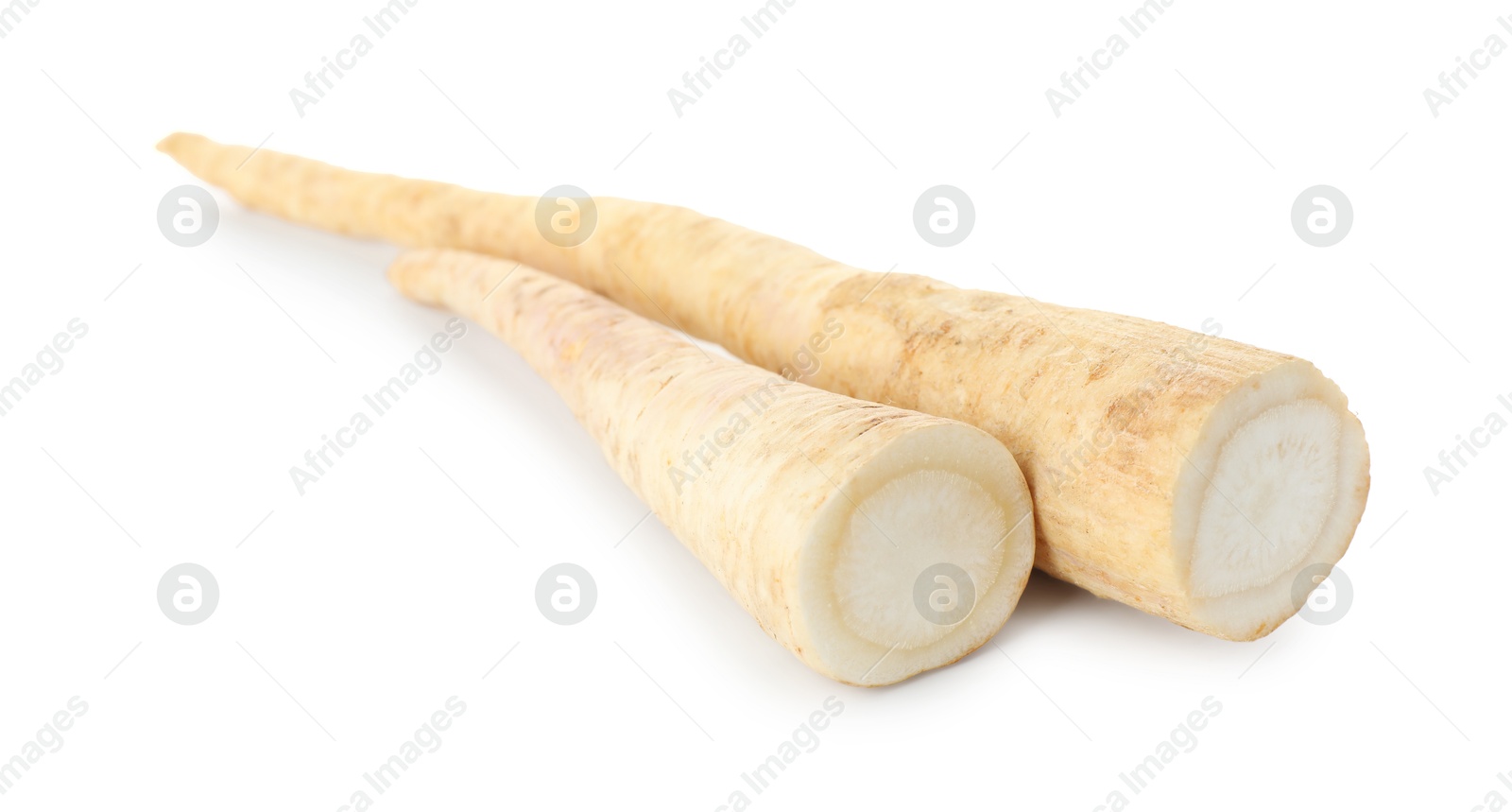 Photo of Cut fresh parsley roots isolated on white