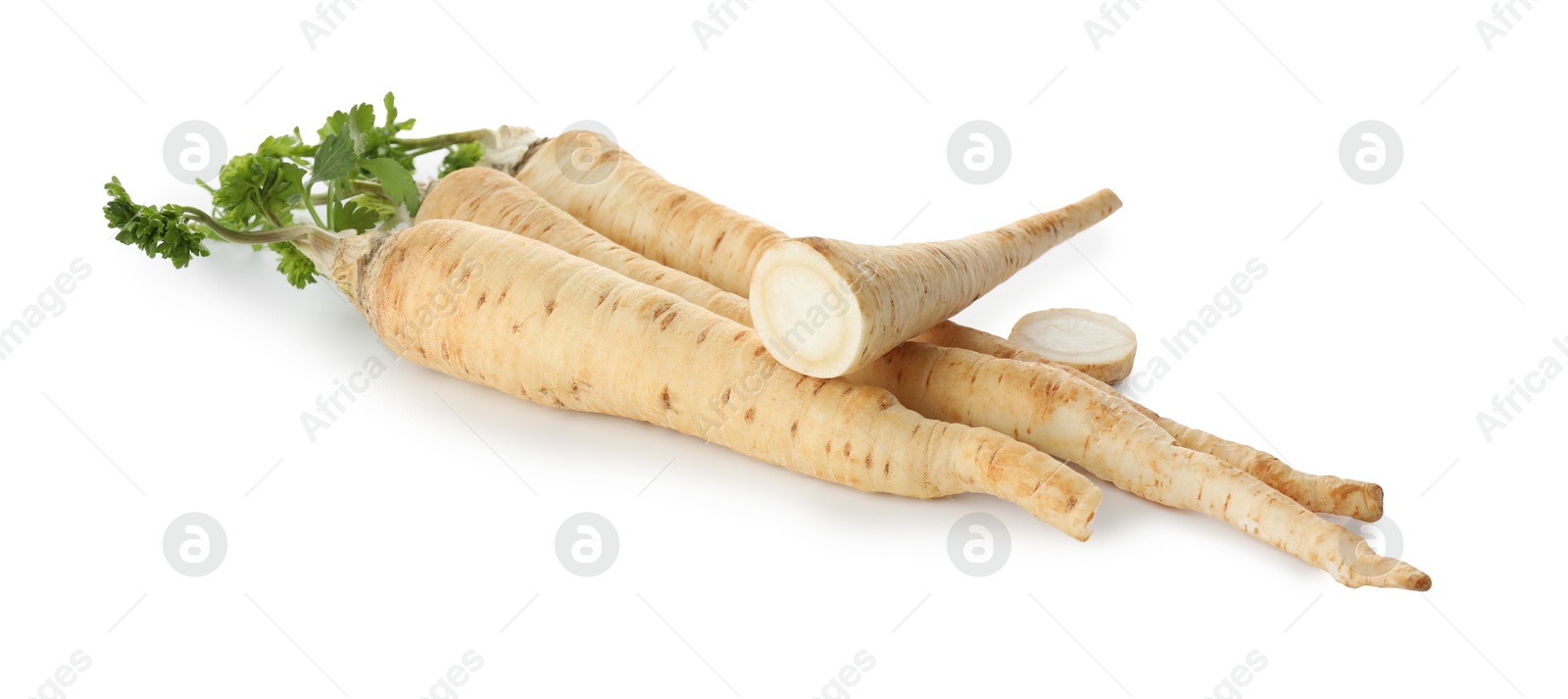 Photo of Whole and cut fresh parsley roots isolated on white