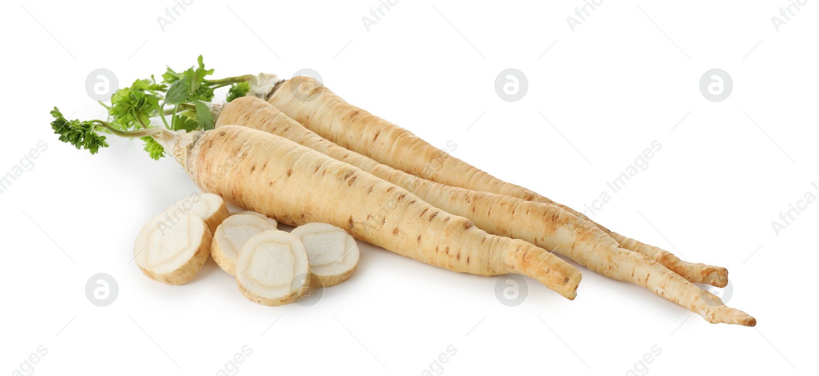 Photo of Whole and cut fresh parsley roots isolated on white