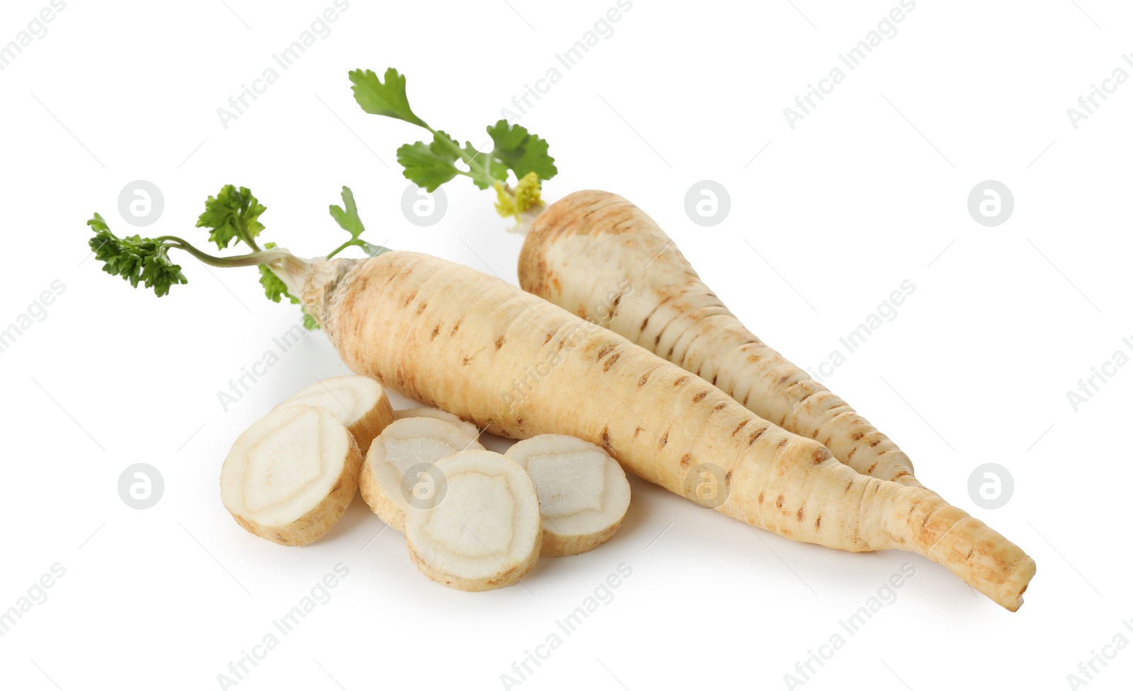 Photo of Whole and cut fresh parsley roots isolated on white