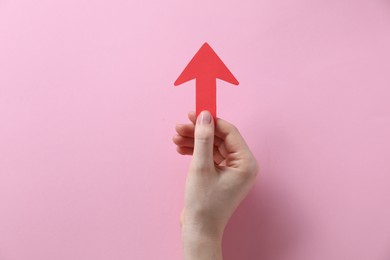 Photo of Woman with paper arrow on pink background, top view. Space for text