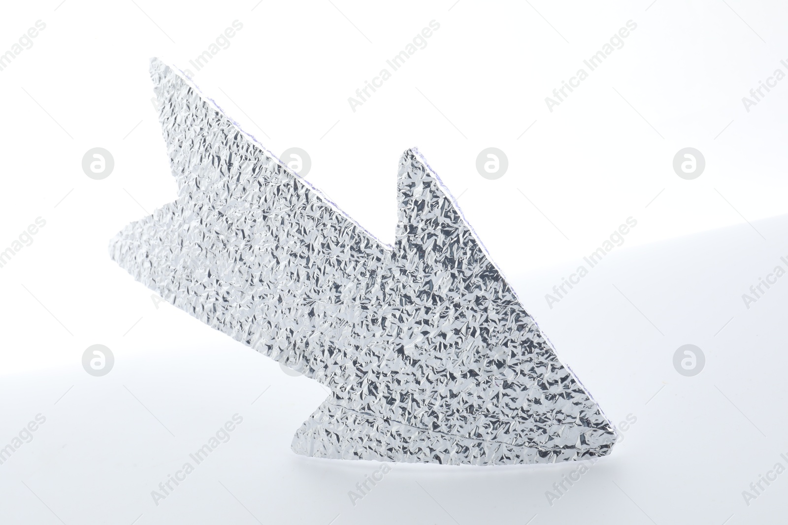 Photo of One silver paper arrow isolated on white