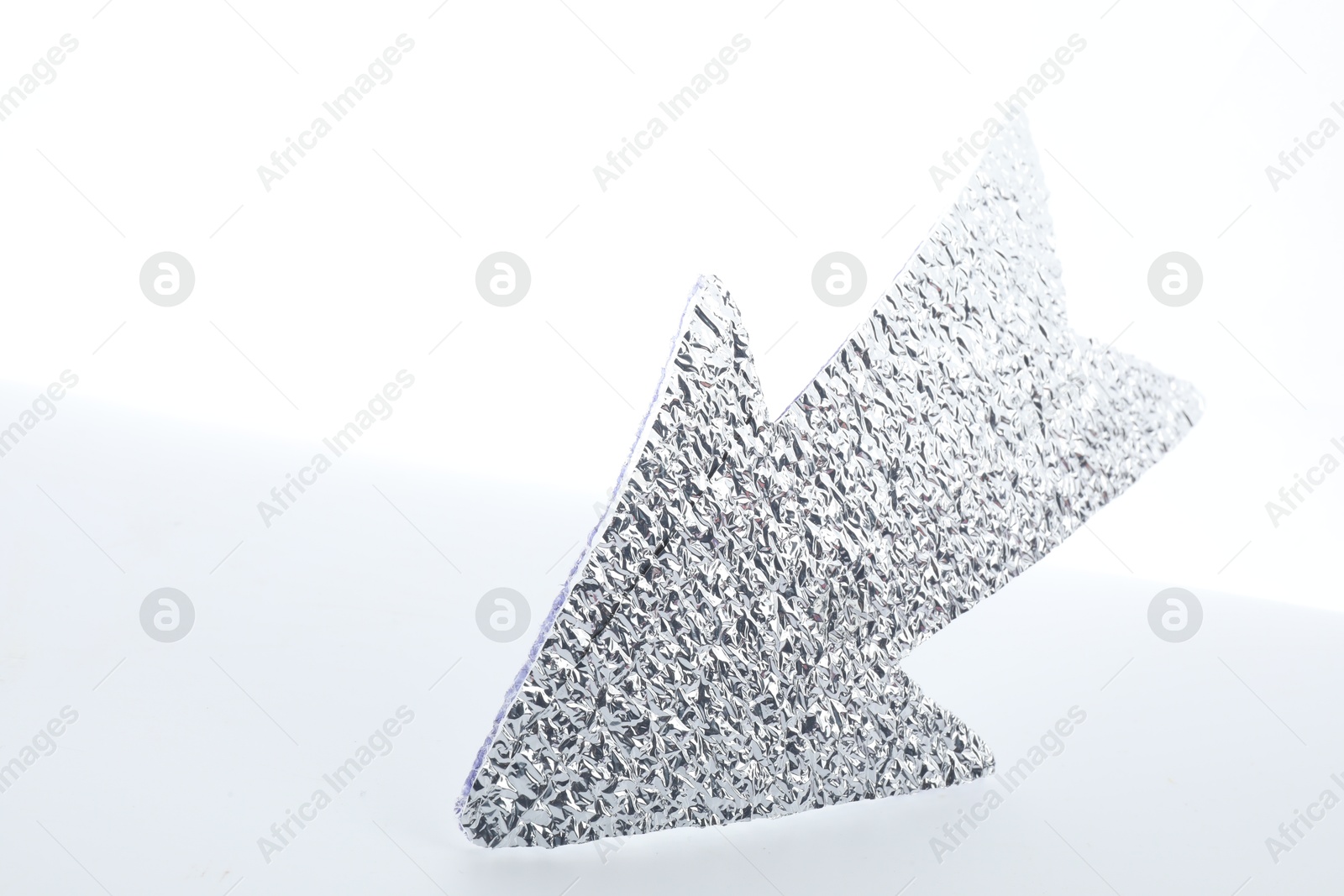 Photo of One silver paper arrow isolated on white