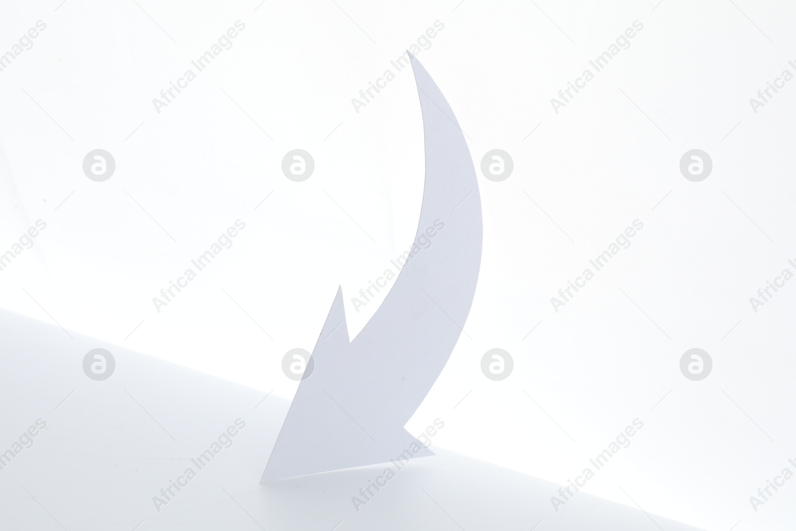 Photo of One cutout paper arrow isolated on white