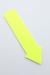 Photo of One yellow paper arrow isolated on white, top view