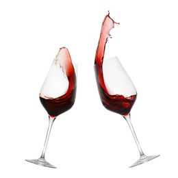 Image of Glasses of splashing red wine isolated on white