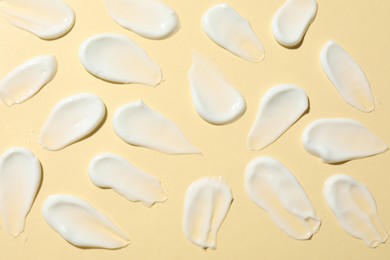 Photo of Body cream on beige background, flat lay