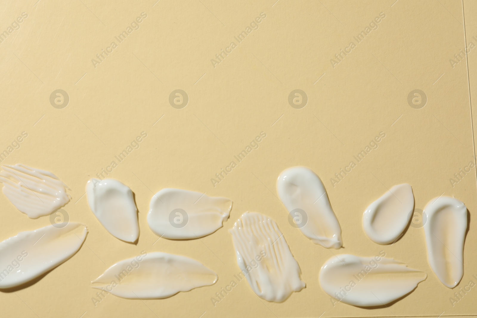 Photo of Body cream on beige background, flat lay. Space for text