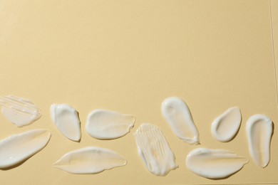 Photo of Body cream on beige background, flat lay. Space for text