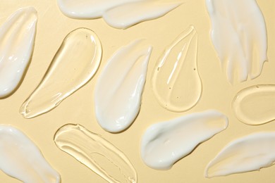 Photo of Body cream and gel on beige background, flat lay